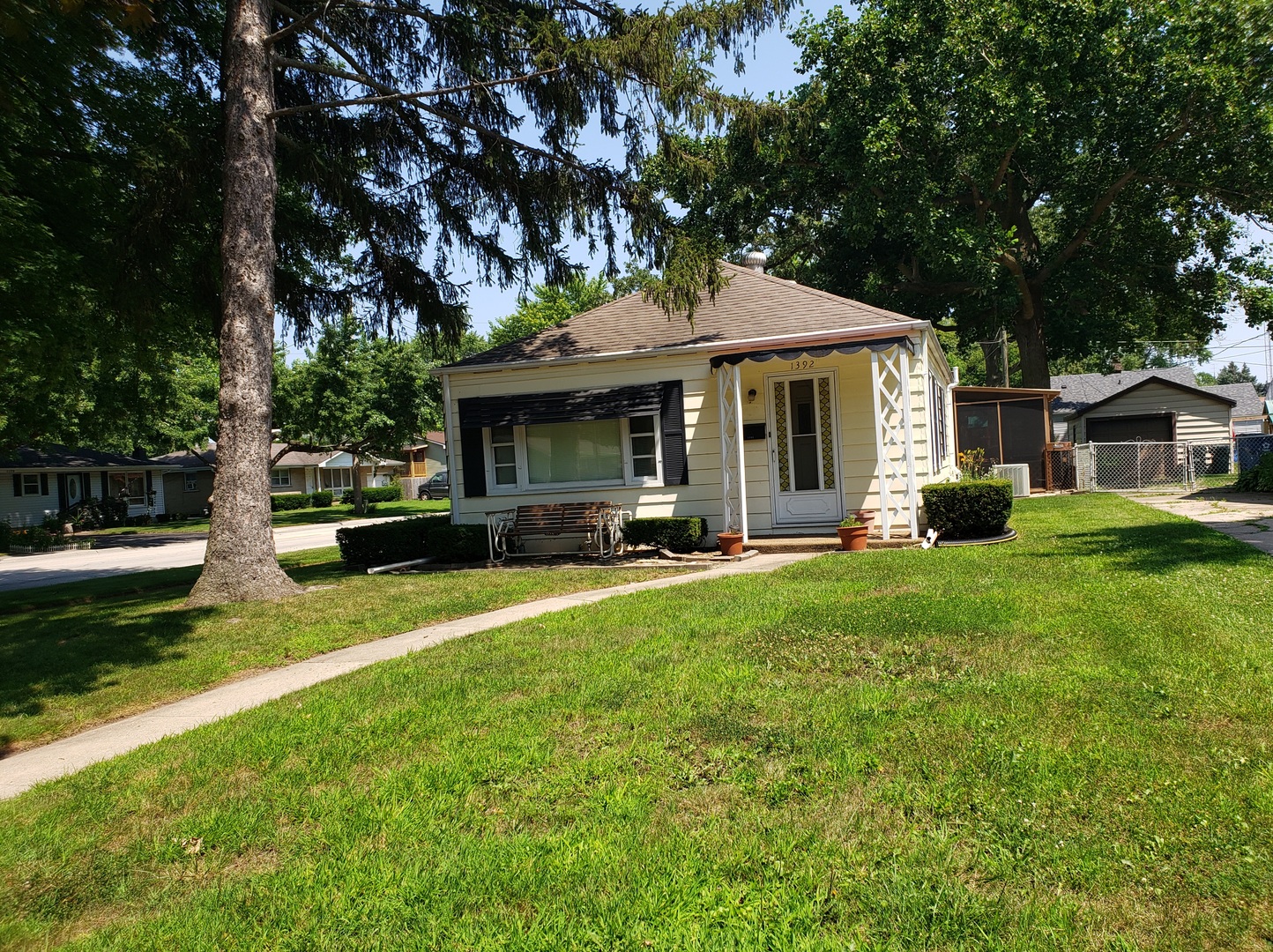 Undisclosed Address Kankakee, IL 60901 - Photo 2 of 35 a front view of a house with a garden and trees