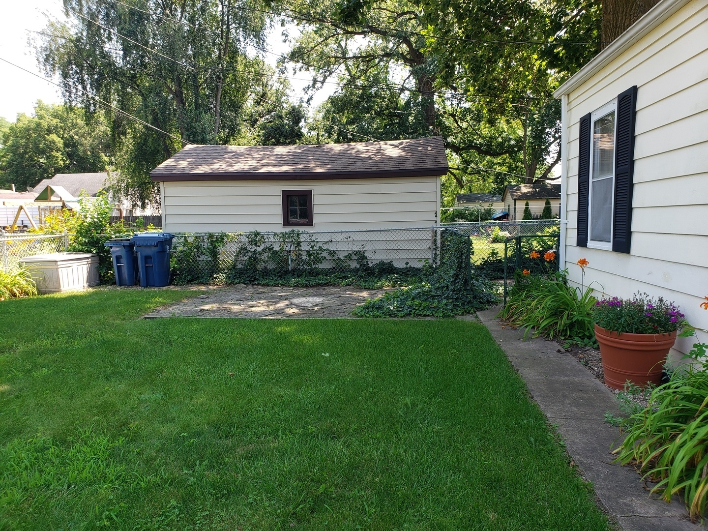 Undisclosed Address Kankakee, IL 60901 - Photo 3 of 35 a view of backyard with potted plants and a large tree