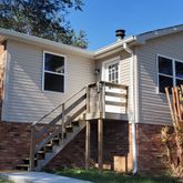 a view of a house with wooden fence