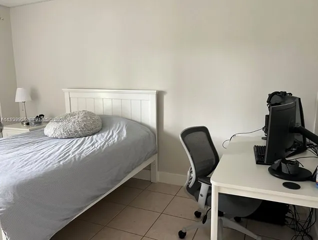 a bedroom with a bed and a chair