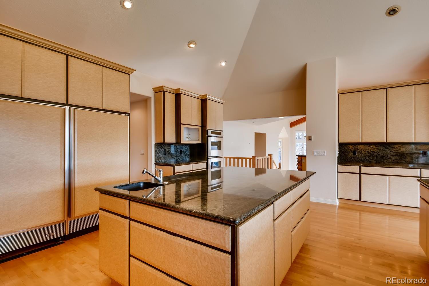3883 Mountainside Trail Evergreen, CO 80439 - Photo 11 of 36 a kitchen with stainless steel appliances granite countertop a sink refrigerator and microwave