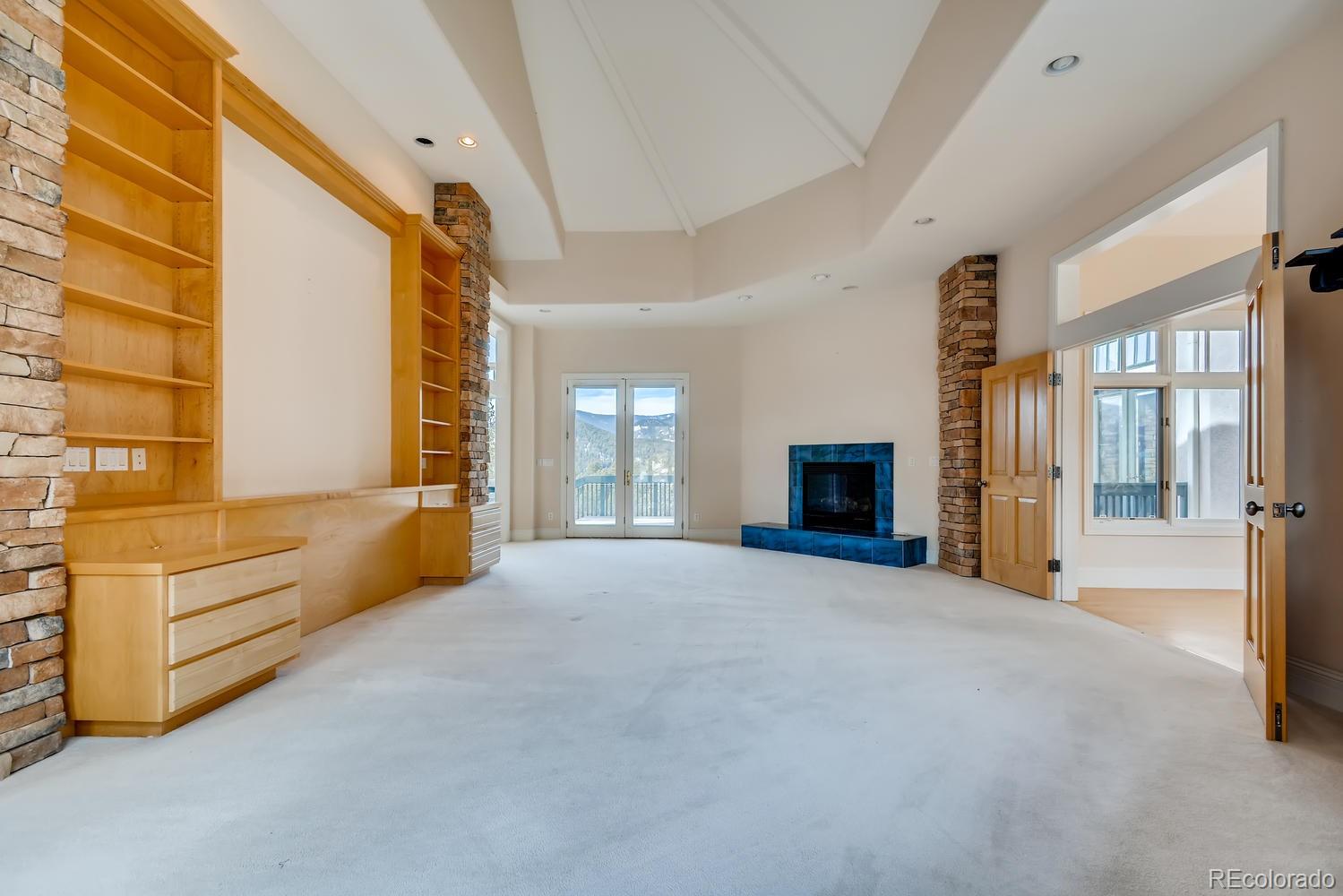 3883 Mountainside Trail Evergreen, CO 80439 - Photo 16 of 36 a view of an empty room with a fireplace and a window