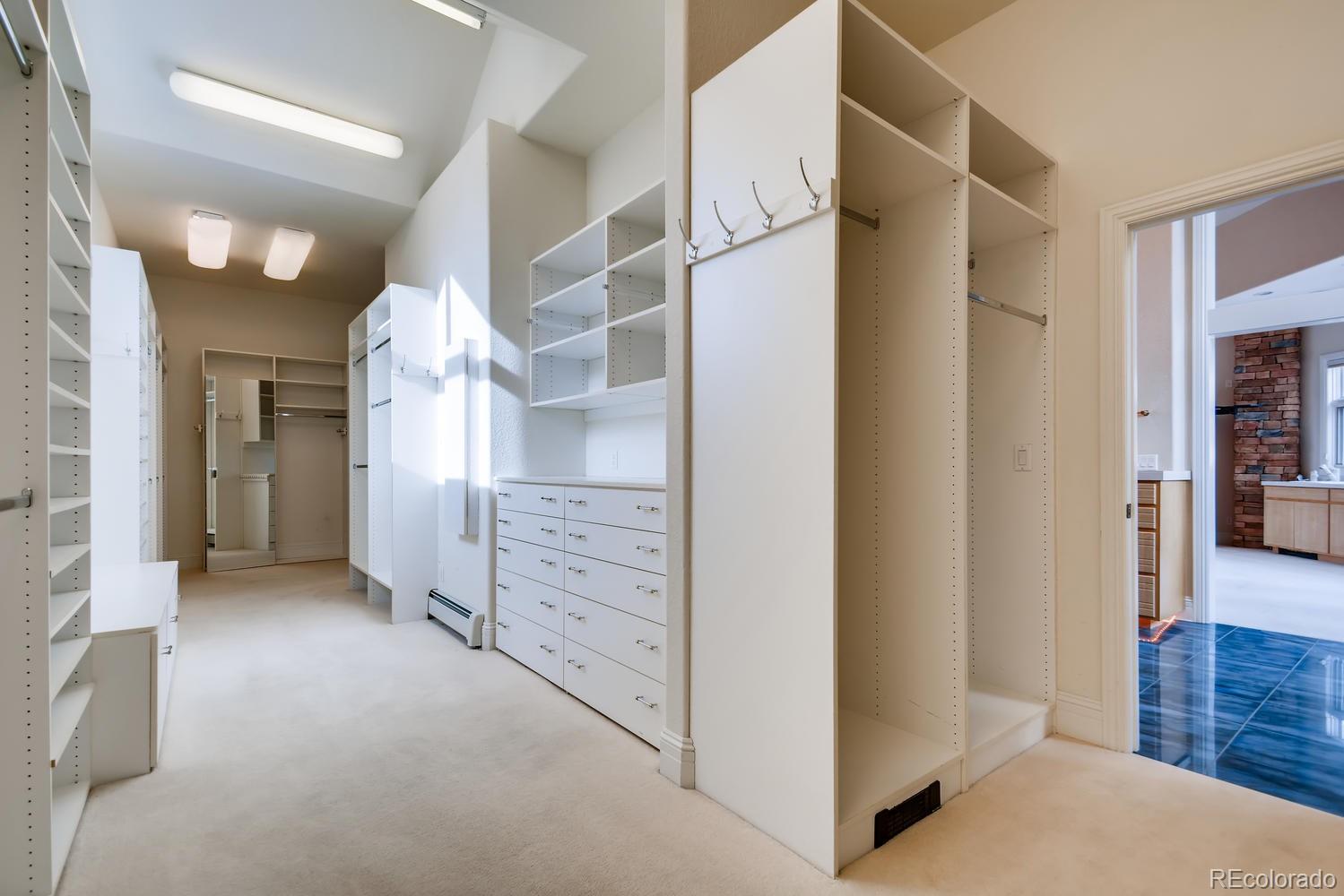3883 Mountainside Trail Evergreen, CO 80439 - Photo 18 of 36 a view of a hallway with cabinets