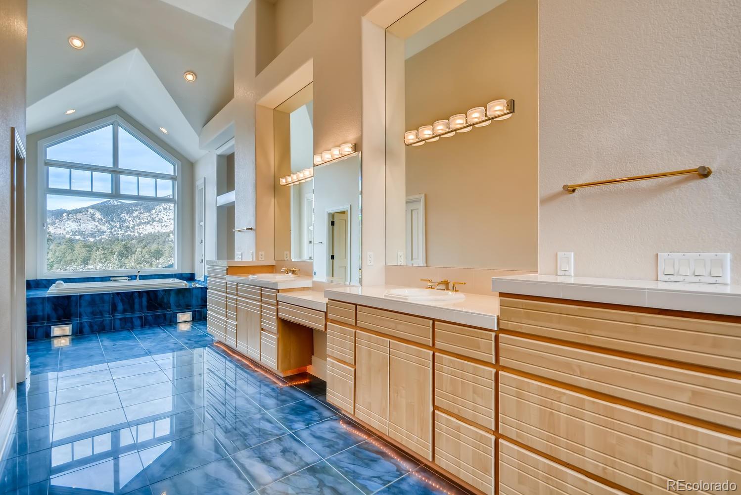 3883 Mountainside Trail Evergreen, CO 80439 - Photo 20 of 36 a large bathroom with a large tub and sink