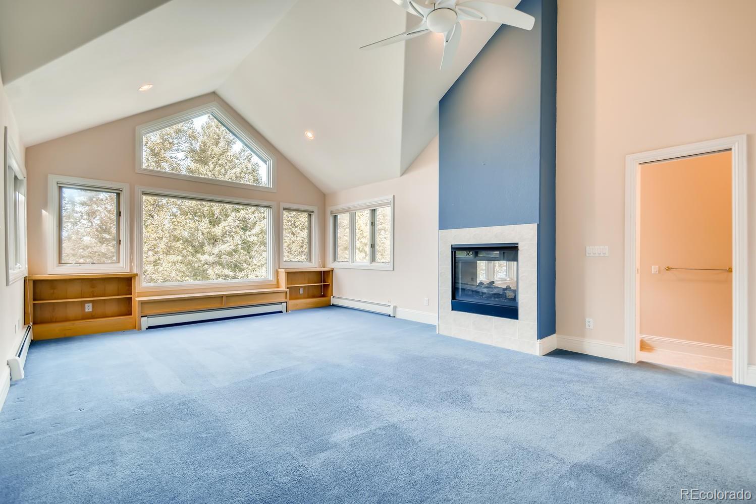 3883 Mountainside Trail Evergreen, CO 80439 - Photo 23 of 36 an empty room with furniture and a fireplace