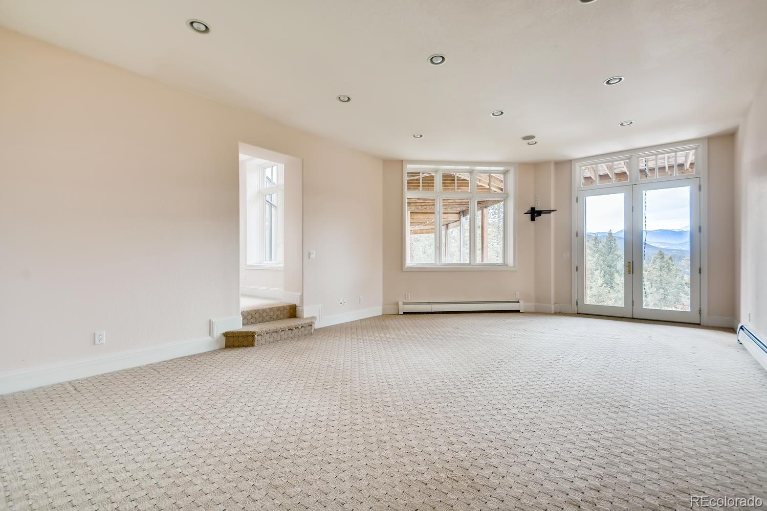 3883 Mountainside Trail Evergreen, CO 80439 - Photo 29 of 36 an empty room with windows
