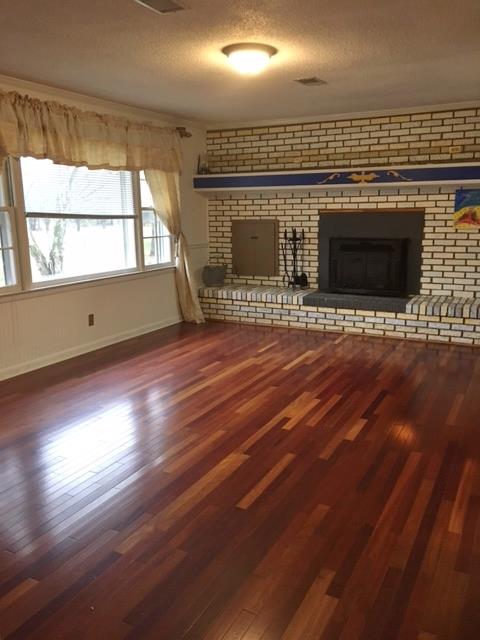 109 Ryans Path Morrison, TN 37357 - Photo 5 of 29 an empty room with wooden floor and fireplace