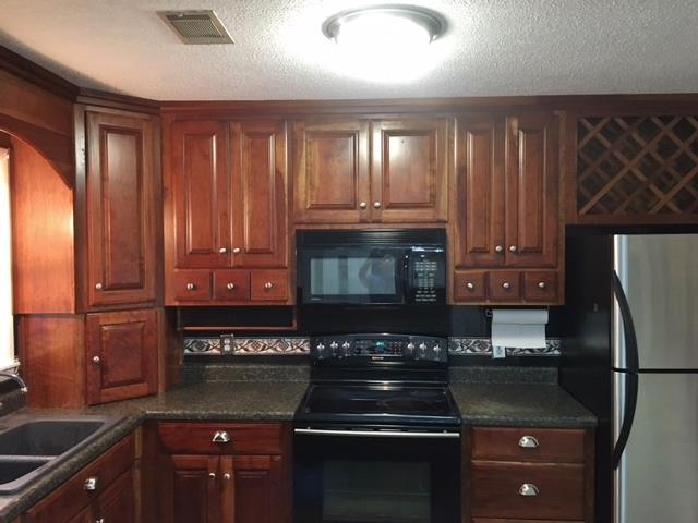 109 Ryans Path Morrison, TN 37357 - Photo 8 of 29 a kitchen with granite countertop wood cabinets and stainless steel appliances