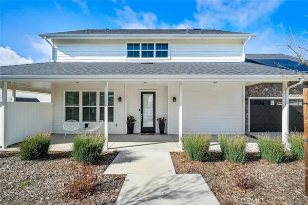 a front view of a house with garden