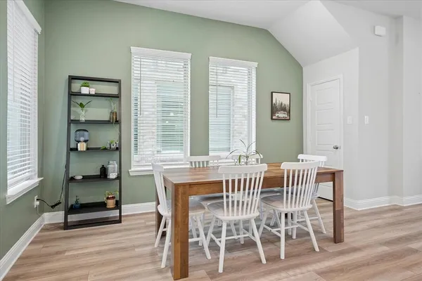 a view of a dining room with furniture and wooden floor
