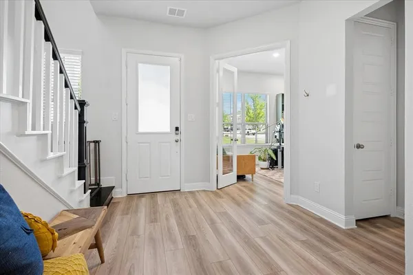 a view of a room with wooden floor and furniture