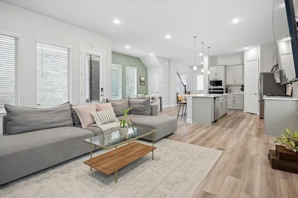 a living room with furniture and kitchen view