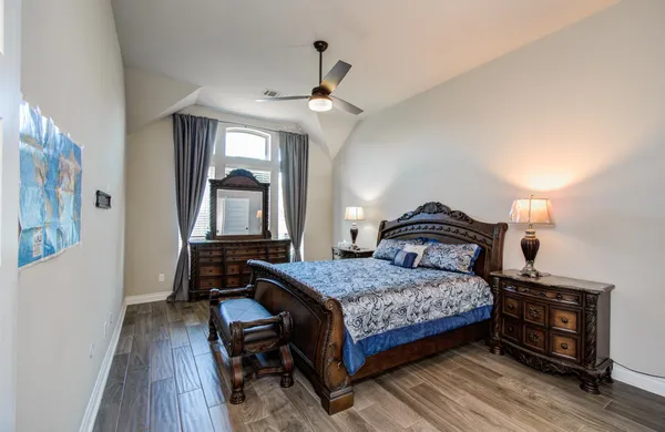 a bedroom with a bed and a lamp