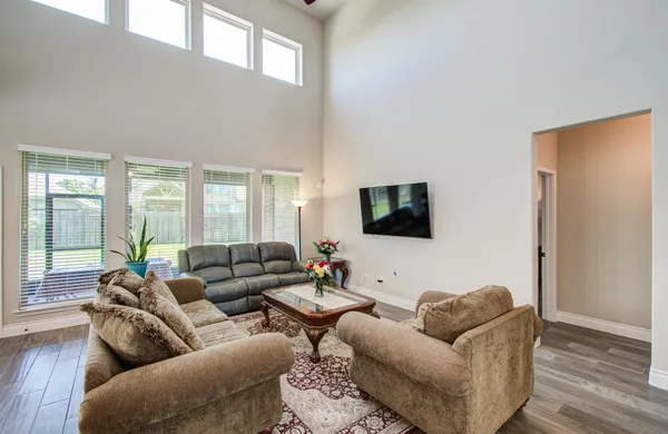 a living room with furniture and a flat screen tv