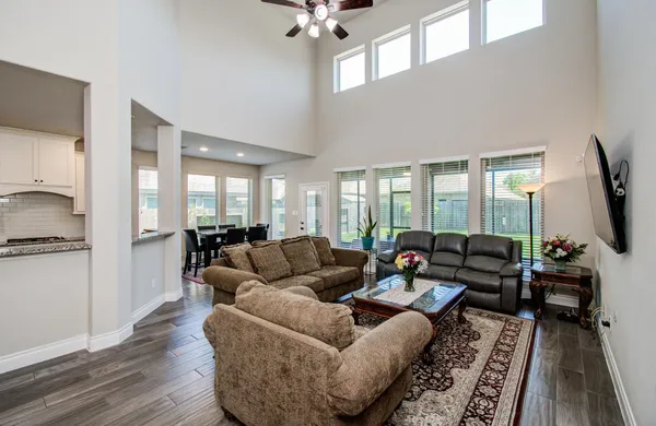 a large kitchen with granite countertop lots of counter top space and stainless steel appliances