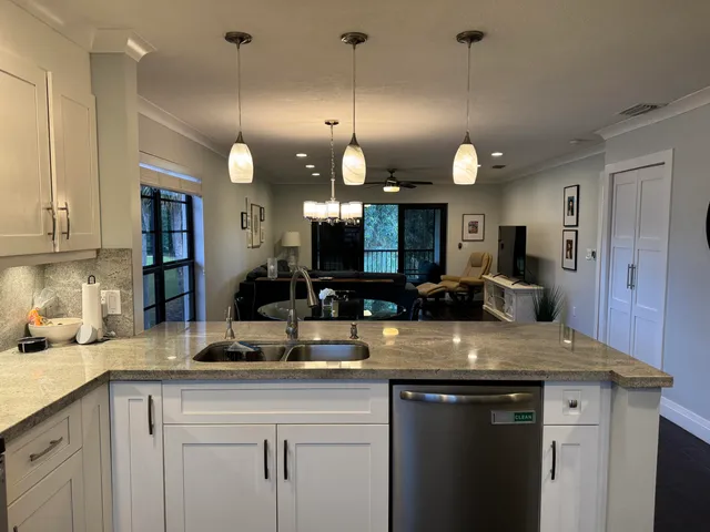 a kitchen with a sink and chandelier
