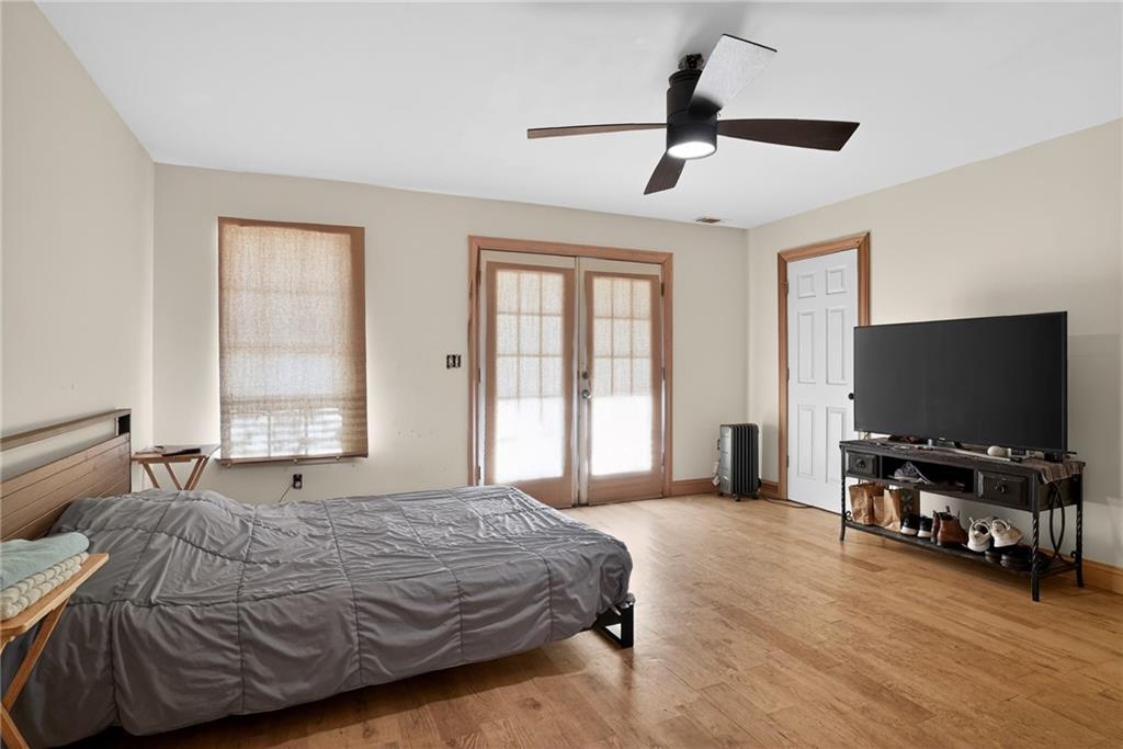 843 Fox Street Northwest Atlanta, GA 30318 - Photo 15 of 30 a bedroom with a bed and a flat screen tv on the dresser