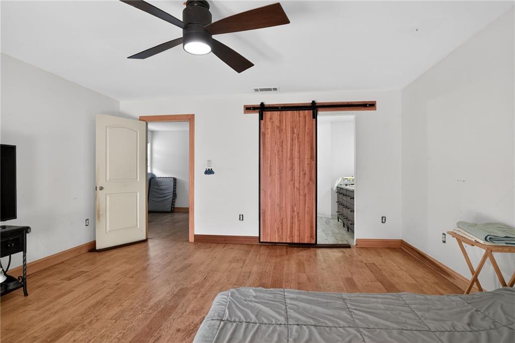 843 Fox Street Northwest Atlanta, GA 30318 - Photo 16 of 30 a view of empty room with wooden floor and fan