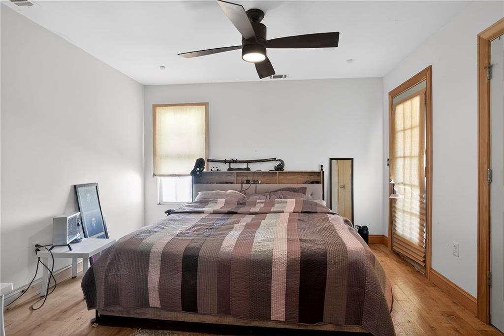 843 Fox Street Northwest Atlanta, GA 30318 - Photo 22 of 30 a bedroom with a bed and wooden floor