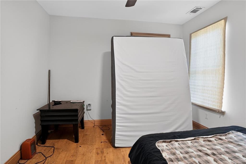 843 Fox Street Northwest Atlanta, GA 30318 - Photo 25 of 30 a bedroom with a bed and a piano