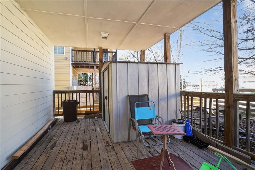 843 Fox Street Northwest Atlanta, GA 30318 - Photo 30 of 30 a view of a balcony with chairs and wooden floor