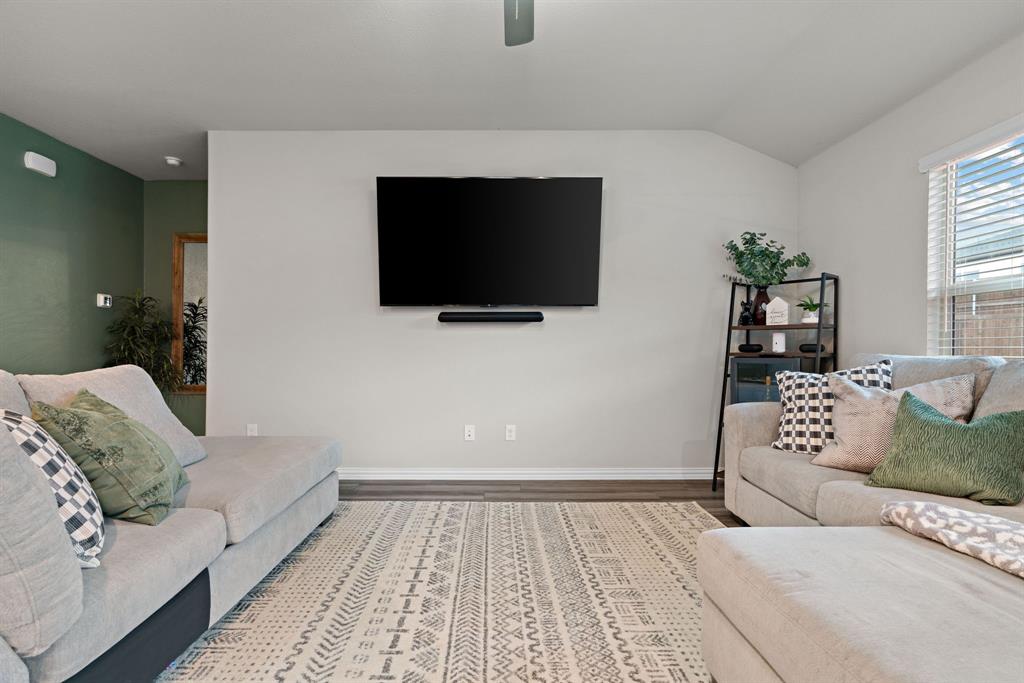 3112 Kingsgarden Road Denton, TX 76207 - Photo 6 of 38 Spacious living area featuring high vaulted ceilings, wood-finish flooring, and a large window with blinds
