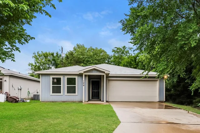 a front view of a house with a garden and yard