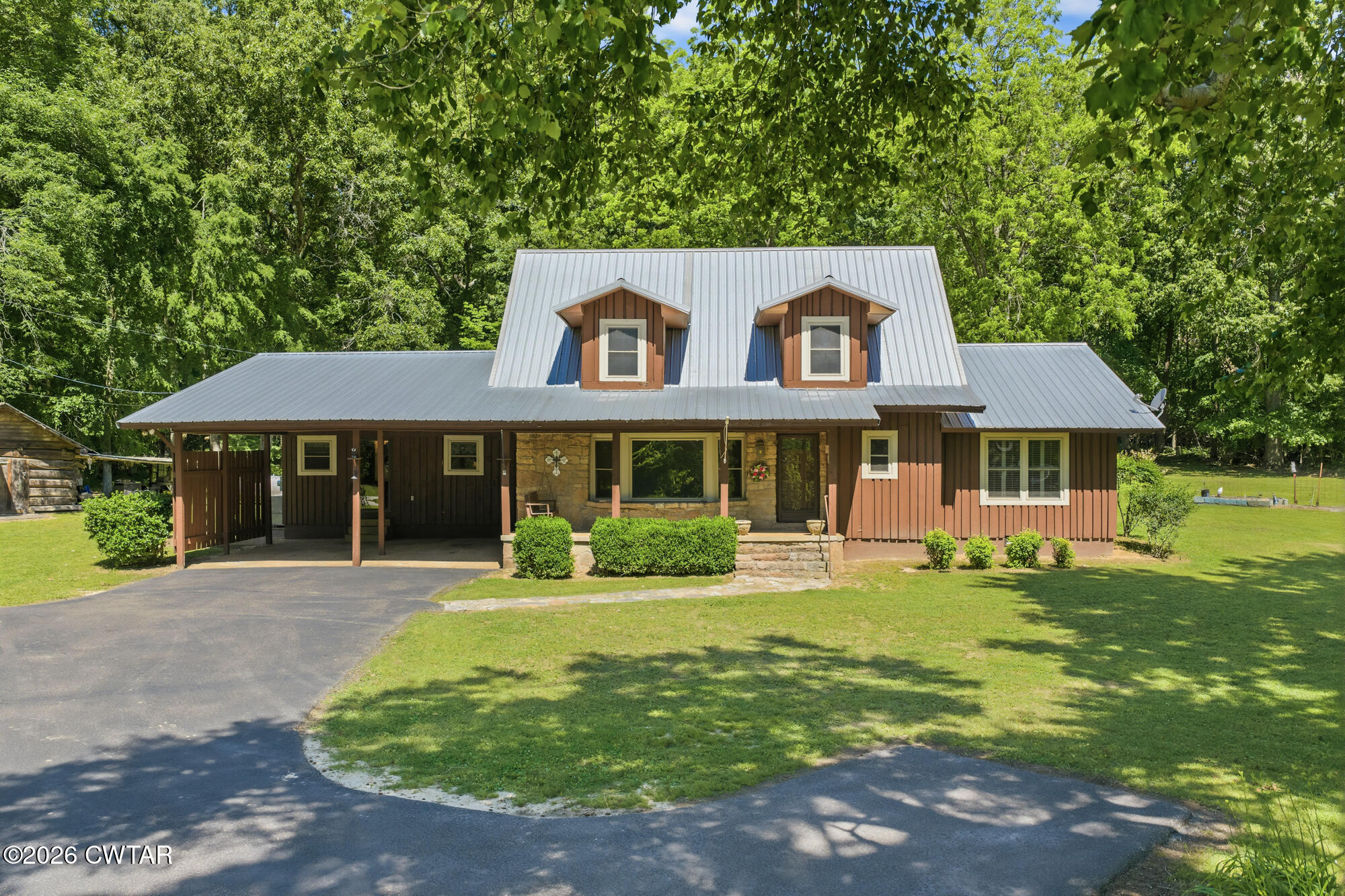 8932 Mt Carmel Road Decaturville, TN 38329 - Photo 1 of 47 a front view of a house with yard and green space
