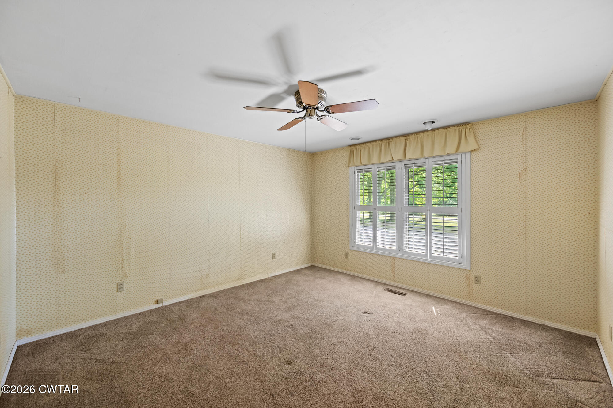 8932 Mt Carmel Road Decaturville, TN 38329 - Photo 13 of 47 a view of a room with a ceiling fan and a window