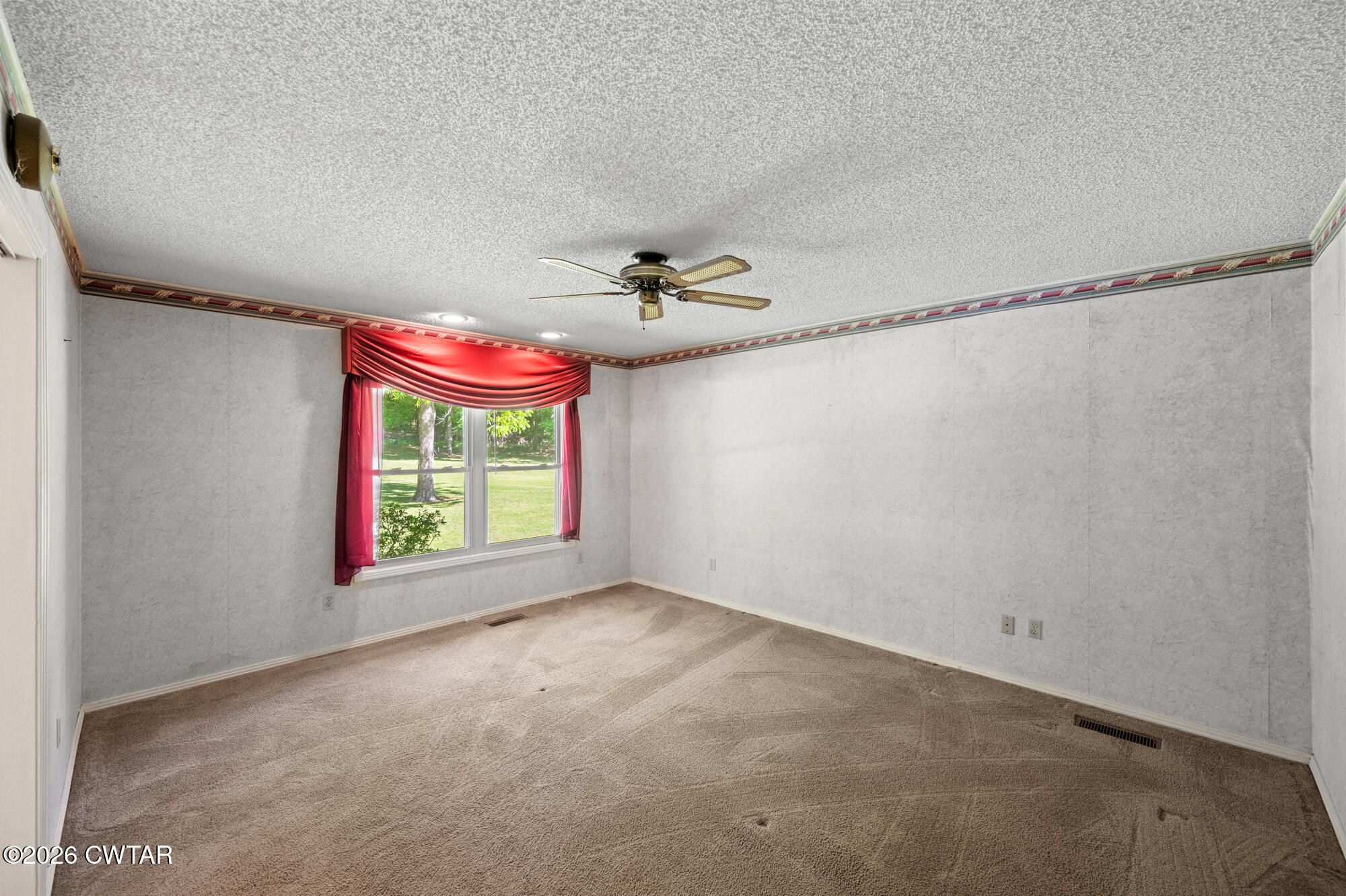 8932 Mt Carmel Road Decaturville, TN 38329 - Photo 18 of 47 a view of a livingroom with a window and a ceiling fan