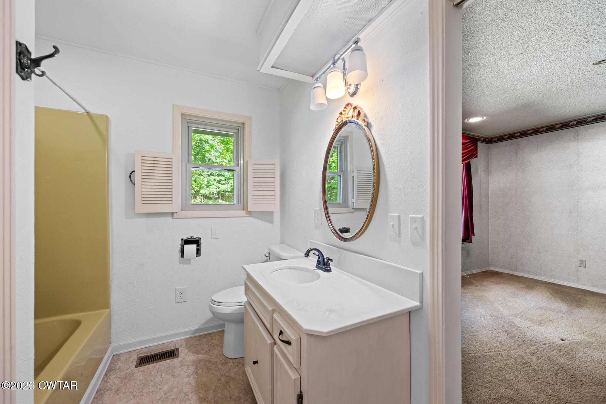 8932 Mt Carmel Road Decaturville, TN 38329 - Photo 19 of 47 a bathroom with a sink a toilet and a mirror