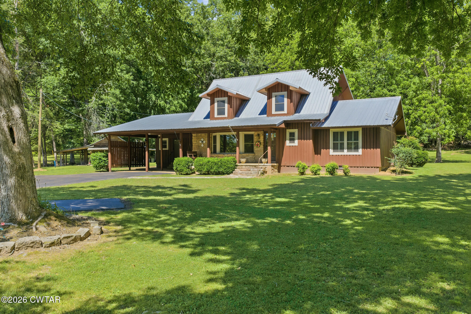 8932 Mt Carmel Road Decaturville, TN 38329 - Photo 2 of 47 a front view of a house with a garden