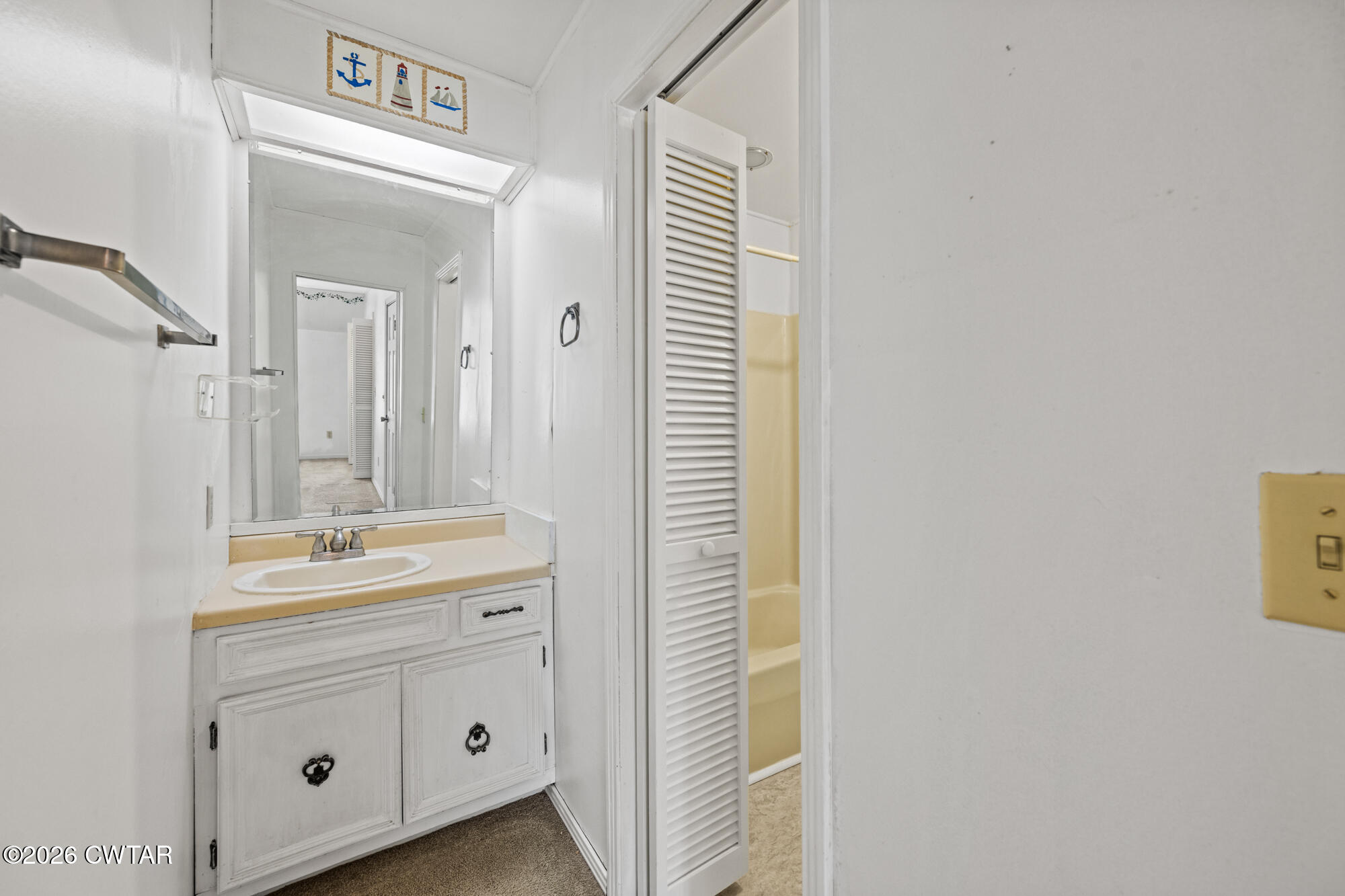 8932 Mt Carmel Road Decaturville, TN 38329 - Photo 24 of 47 a bathroom with a sink a mirror and a vanity