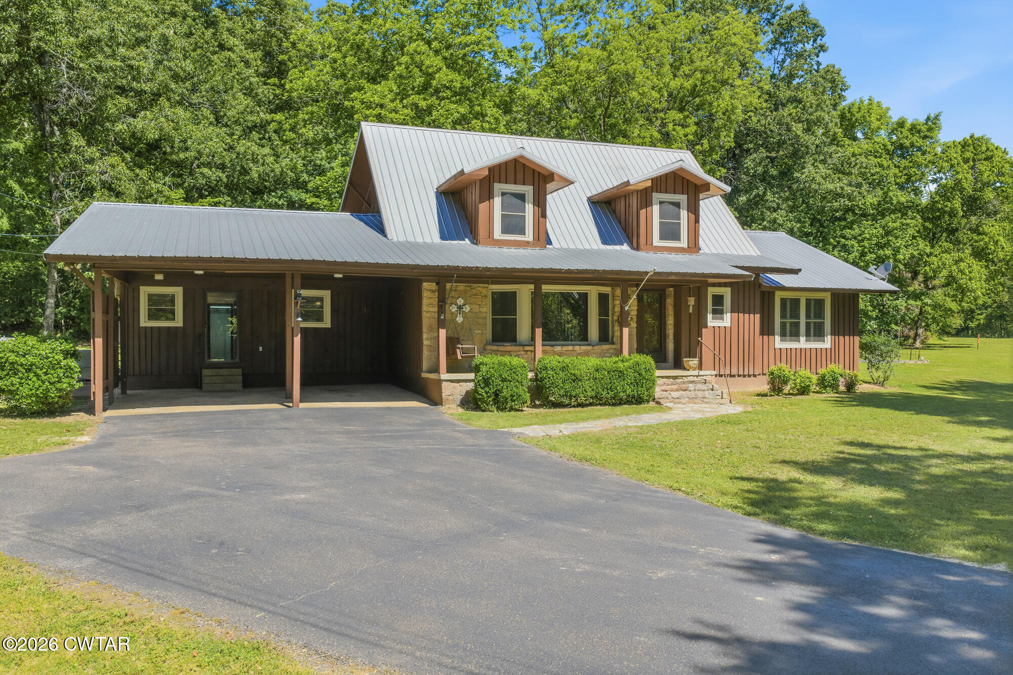 8932 Mt Carmel Road Decaturville, TN 38329 - Photo 35 of 47 a front view of a house with a yard and garage