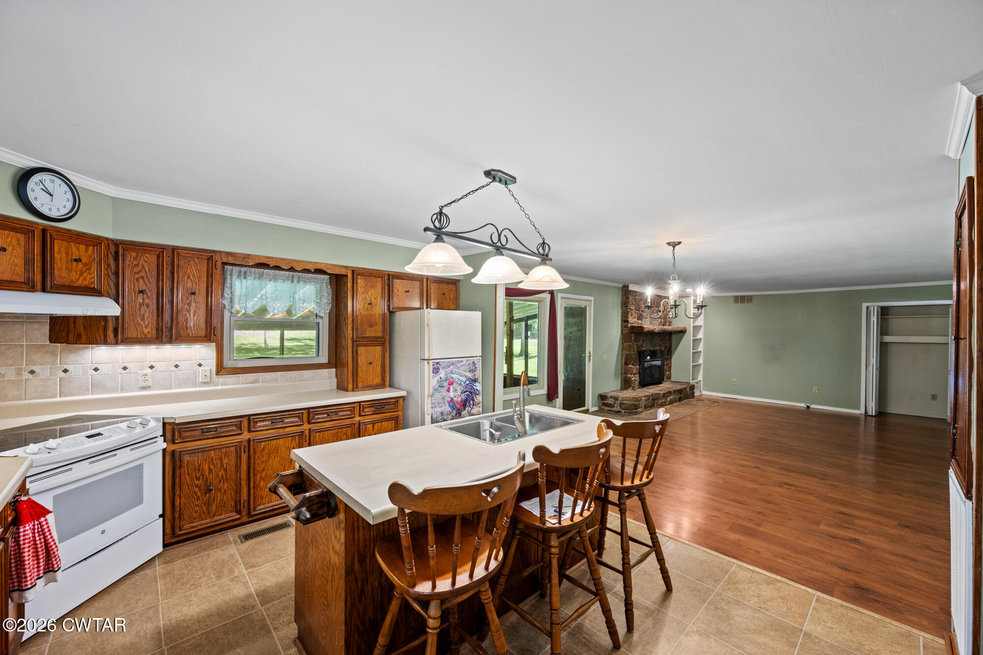 8932 Mt Carmel Road Decaturville, TN 38329 - Photo 4 of 47 a dining hall with stainless steel appliances a kitchen island a stove a table and chairs in it