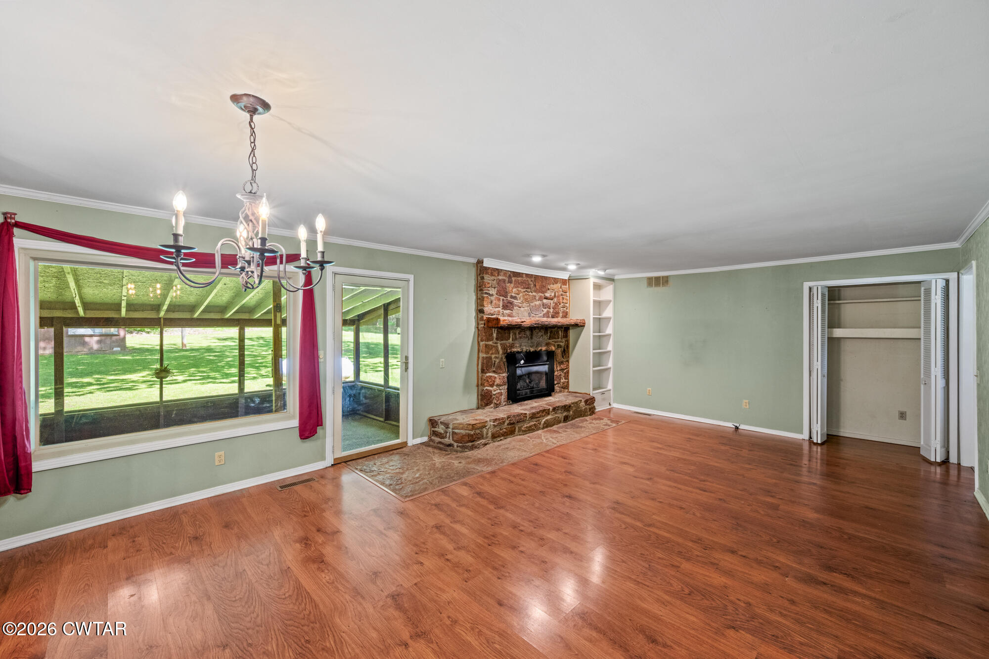 8932 Mt Carmel Road Decaturville, TN 38329 - Photo 5 of 47 a view of an empty room with window and fire place