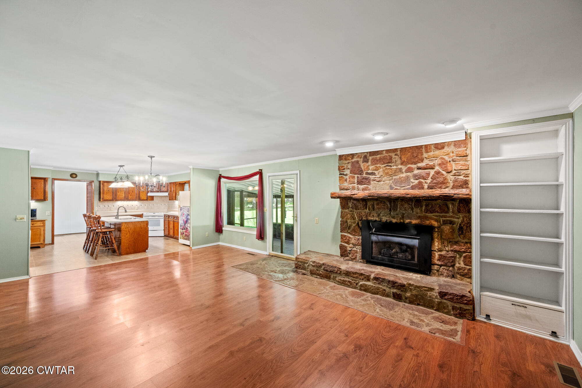 8932 Mt Carmel Road Decaturville, TN 38329 - Photo 6 of 47 a living room with furniture and a fireplace