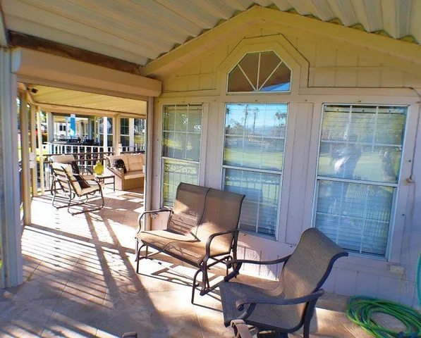 a view of a dining room with furniture wooden floor and a chandelier
