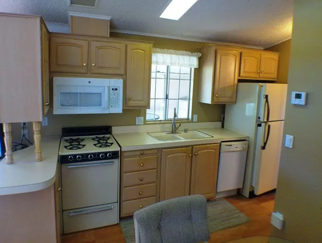 a kitchen with a stove a refrigerator and a sink