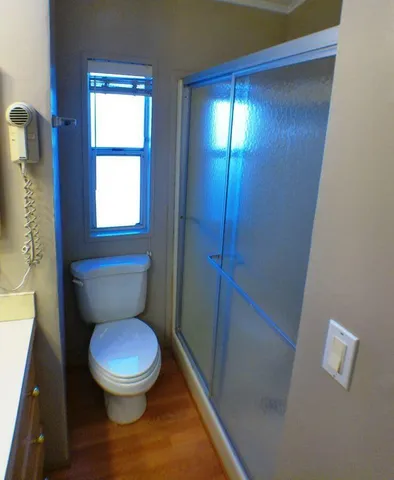 a white toilet sitting next to a window