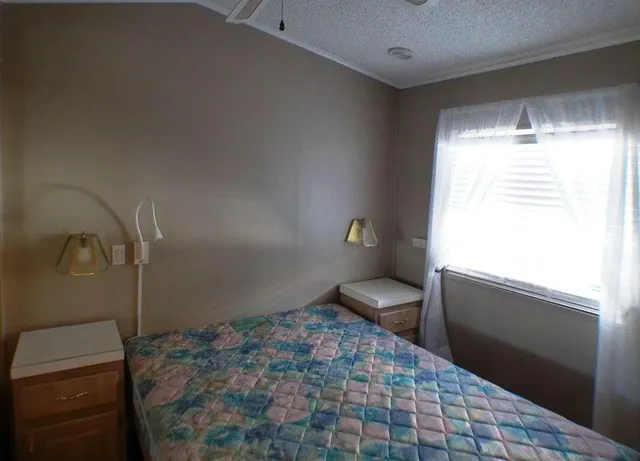 a bathroom with a granite countertop sink a toilet and a shower