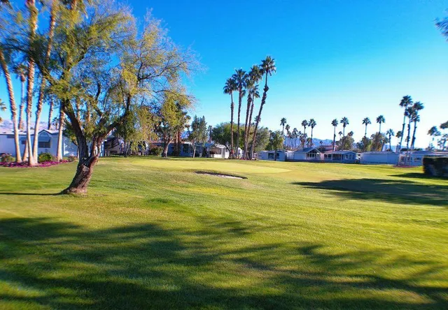 a view of a swimming pool with an outdoor space and seating area