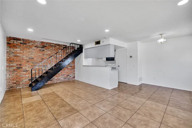 a kitchen with kitchen island granite countertop a stove top oven and cabinets