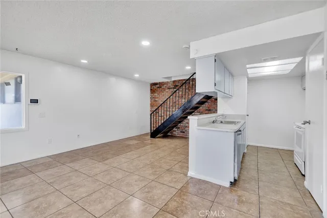 a kitchen with a sink appliances and cabinets