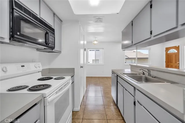 a kitchen with stainless steel appliances granite countertop a sink and a stove top oven