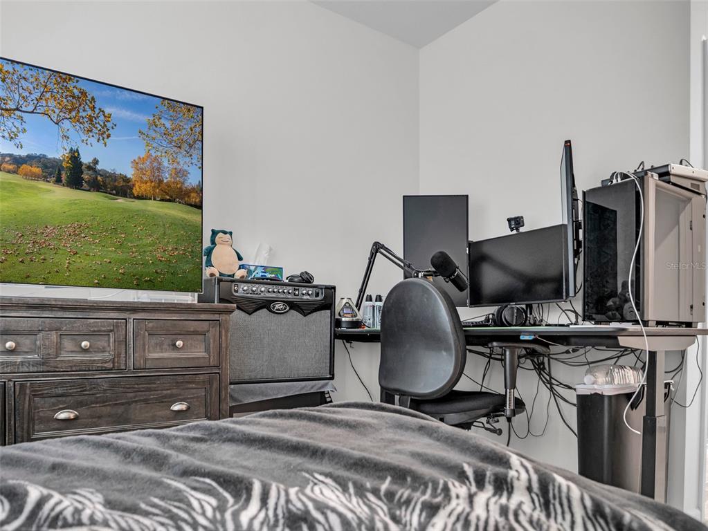 7474 Southwest 78th Terrace Ocala, FL 34481 - Photo 15 of 58 a bedroom with a bed and flat screen tv