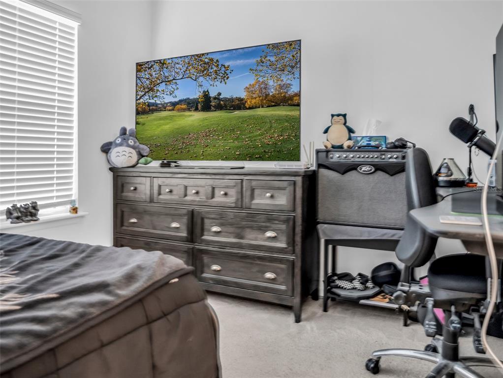 7474 Southwest 78th Terrace Ocala, FL 34481 - Photo 35 of 58 a bedroom with a bed and a view of living room
