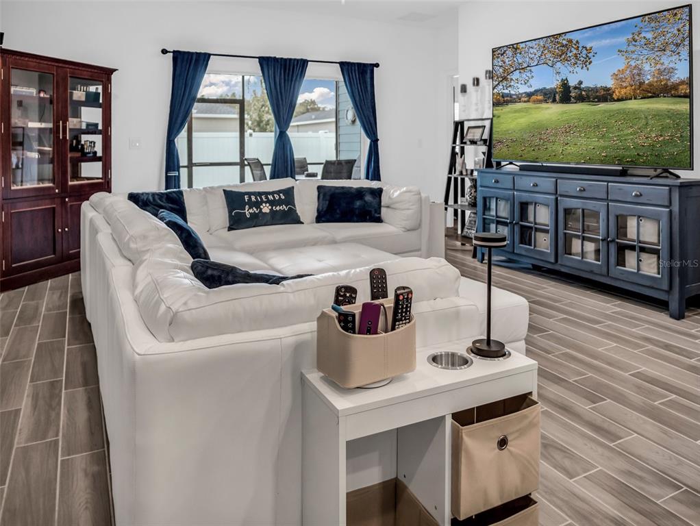 7474 Southwest 78th Terrace Ocala, FL 34481 - Photo 36 of 58 a living room with furniture and a flat screen tv