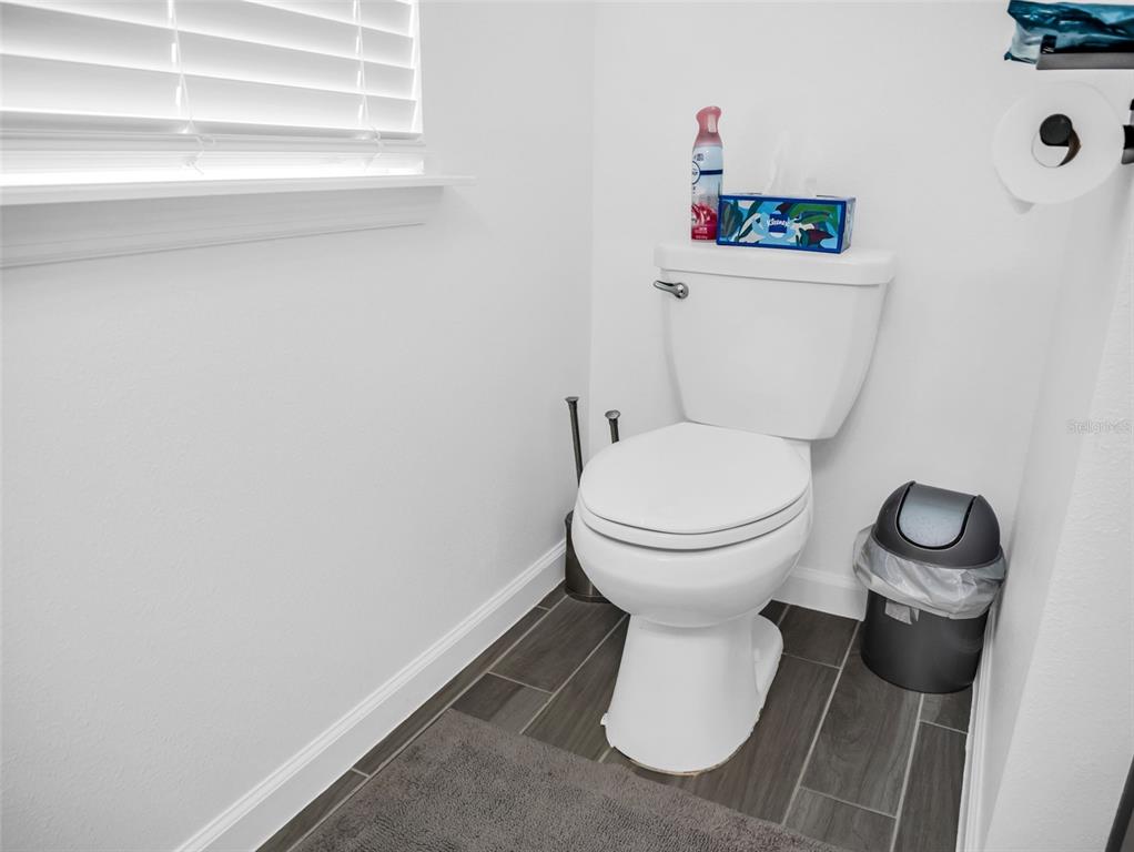 7474 Southwest 78th Terrace Ocala, FL 34481 - Photo 41 of 58 a white toilet sitting next to a bathroom sink