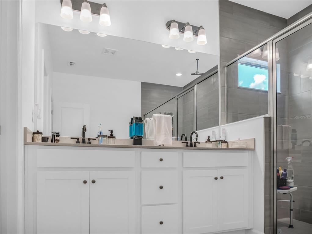 7474 Southwest 78th Terrace Ocala, FL 34481 - Photo 46 of 58 a bathroom with a sink double vanity and a mirror